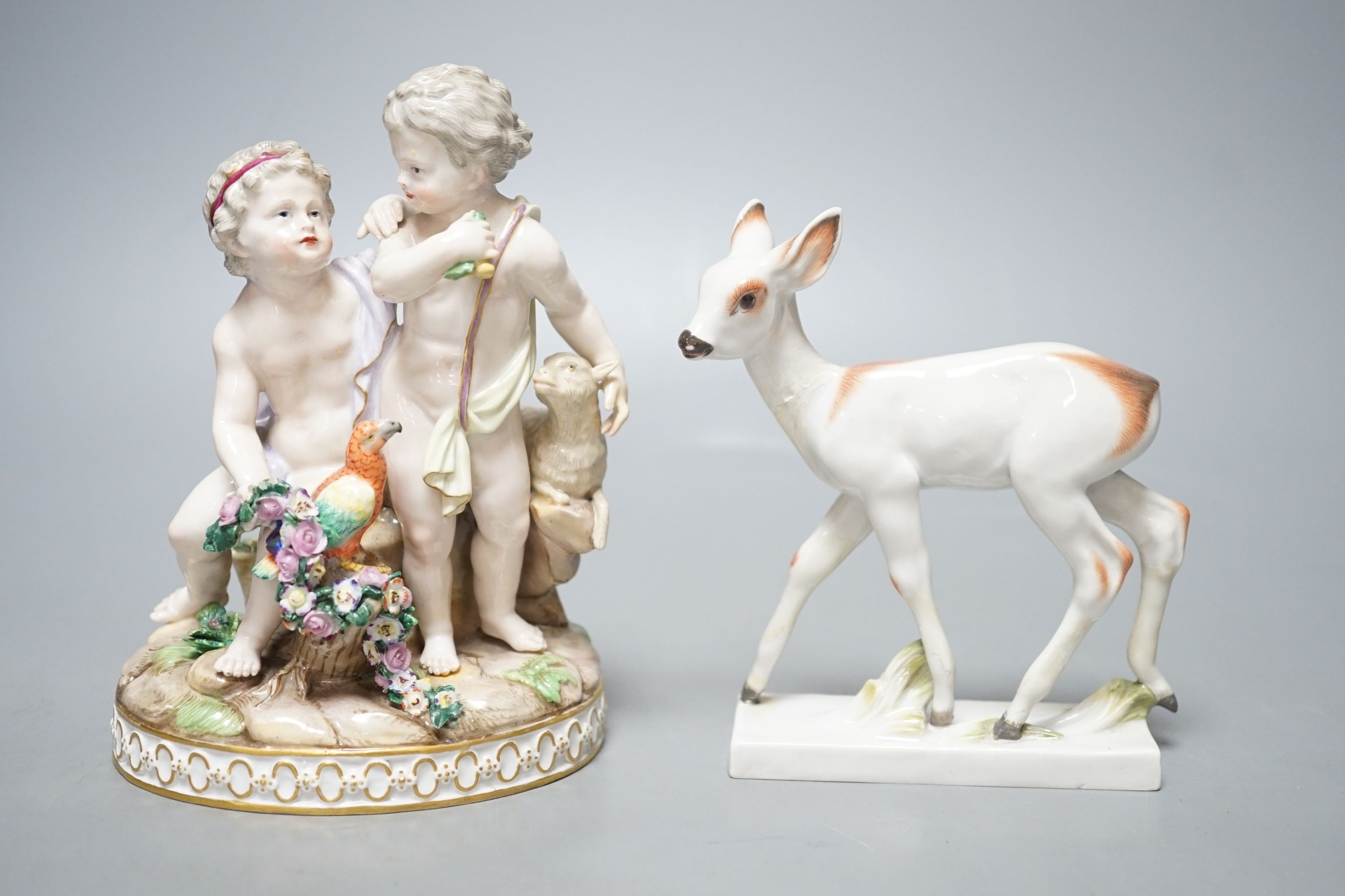 A Meissen group of Amorini with a lamb and a parrot, and a Meissen model of a fawn, incised number 1490 (2)